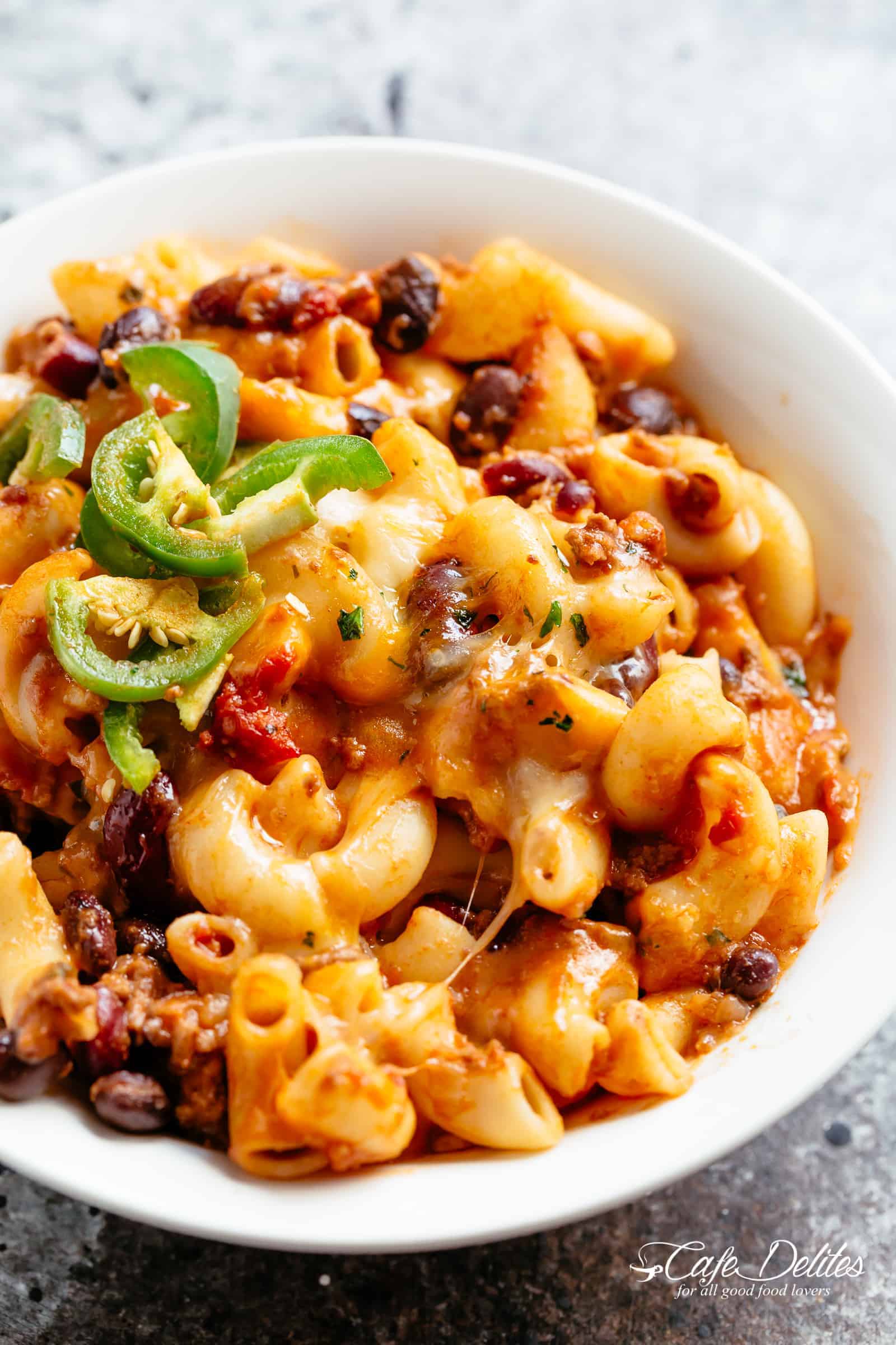 Chili Mac and Cheese with beans is the ultimate mash up of TWO favourites -- Chili PLUS Mac and Cheese! Using leftover chili OR chili made from scratch, this casserole is ready and on the table in less than 30 minutes! Incredible flavours that the whole family will go crazy for! | cafedelites.com