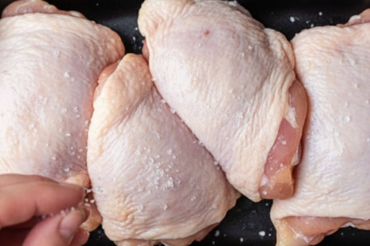 Pat the chicken thighs or breasts dry and season lightly with a pinch of salt.