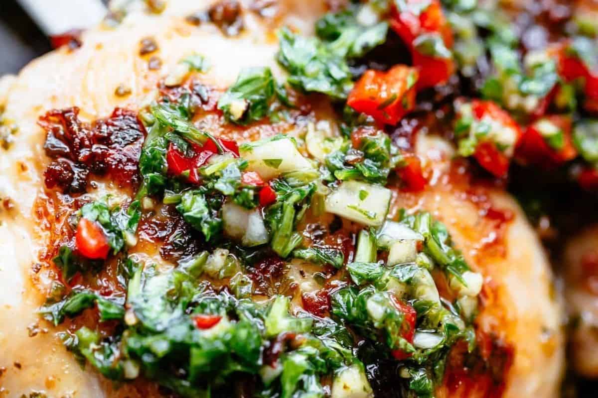 Transfer the chicken to a plate and let it rest briefly. Spoon 2–3 tablespoons of the reserved chimichurri over each piece.