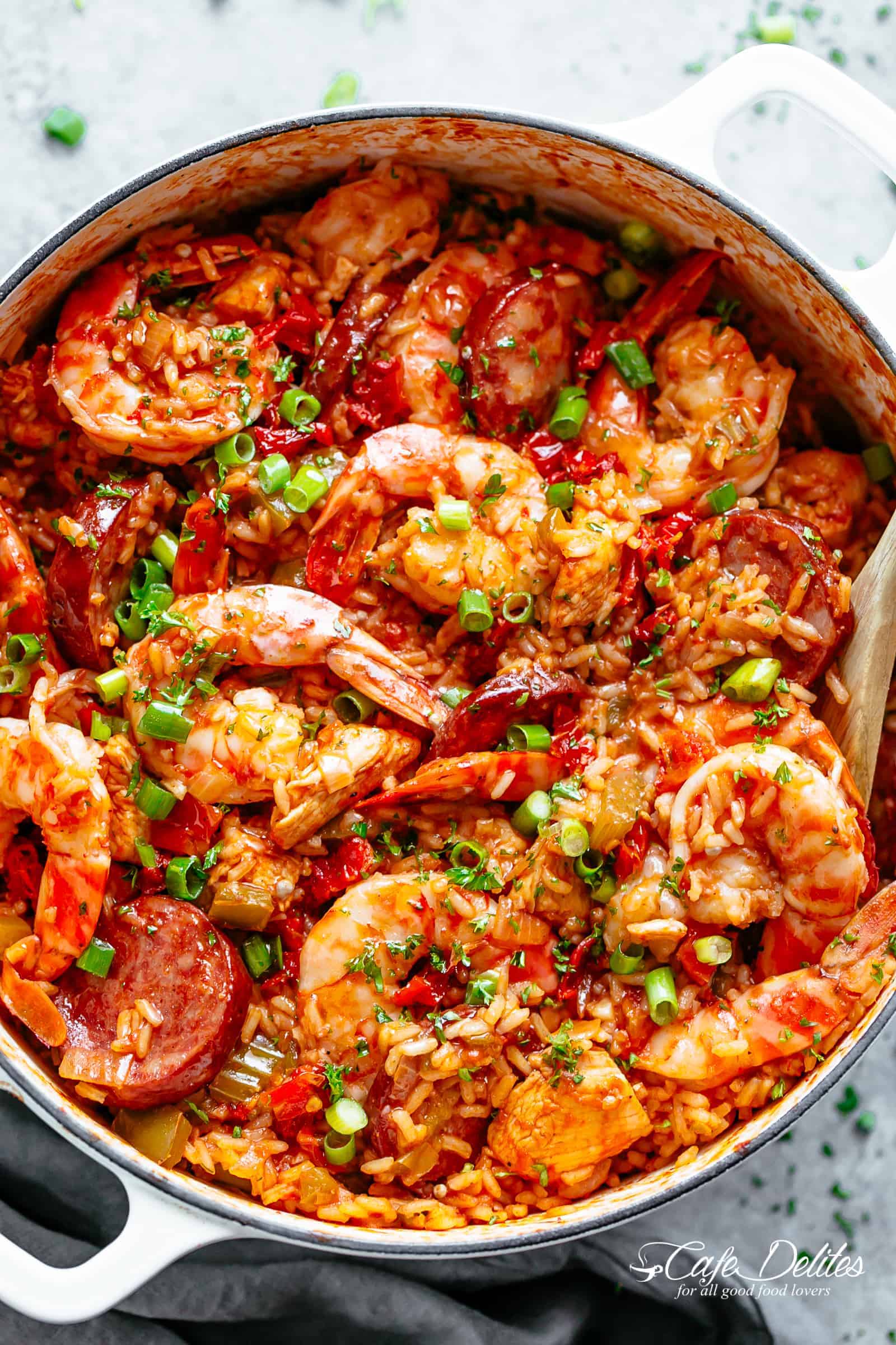 An authentic Creole Jambalaya recipe! A delicious one-pot meal coming to you from New Orleans is pure comfort food filled to the brim with chicken, shrimp, andouille sausage, rice, seasonings, spices and incredible flavours! Ready and on the table in 45 minutes! | cafedelites.com