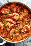 An authentic Creole Jambalaya recipe! A delicious one-pot meal coming to you from New Orleans is pure comfort food filled to the brim with chicken, shrimp, andouille sausage, rice, seasonings, spices and incredible flavours! Ready and on the table in 45 minutes! | cafedelites.com