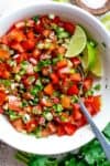 Pico De Gallo is a super easy to make fresh tomato salsa you can serve with anything! From tortilla chips to tacos, enchiladas or Carne Asada! With a handful of ingredients, this Pico De Gallo is the perfect accompaniment! Also called salsa fresca or salsa cruda! | cafedelites.com