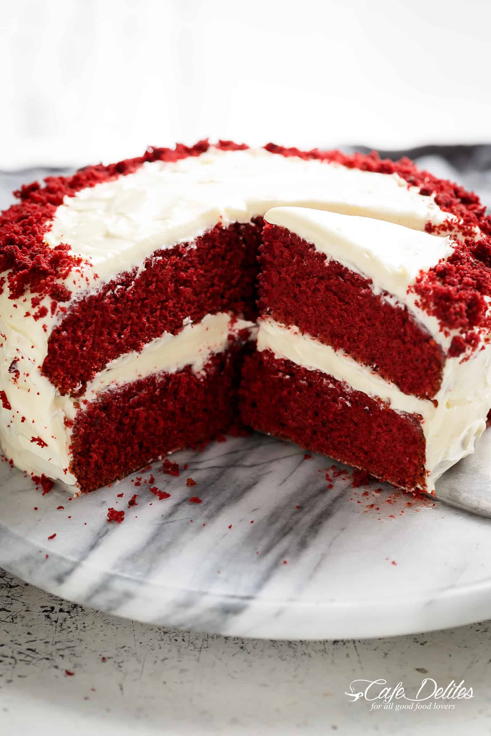 The most incredible Red Velvet Cake with Cream Cheese Frosting is fluffy, soft, buttery and moist with the most perfect velvet texture! Super easy to make with a few tips and tricks for the best results! You will go crazy for a second slice! | cafedelites.com