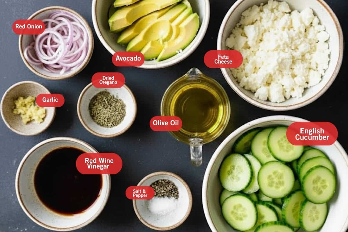 Flat lay photo of ingredient shot of red onion, avocado, feta cheese, garlic, olive oil dried oregano, olive oil, English cucumber, salt and pepper, red wine vinegar,  - 2