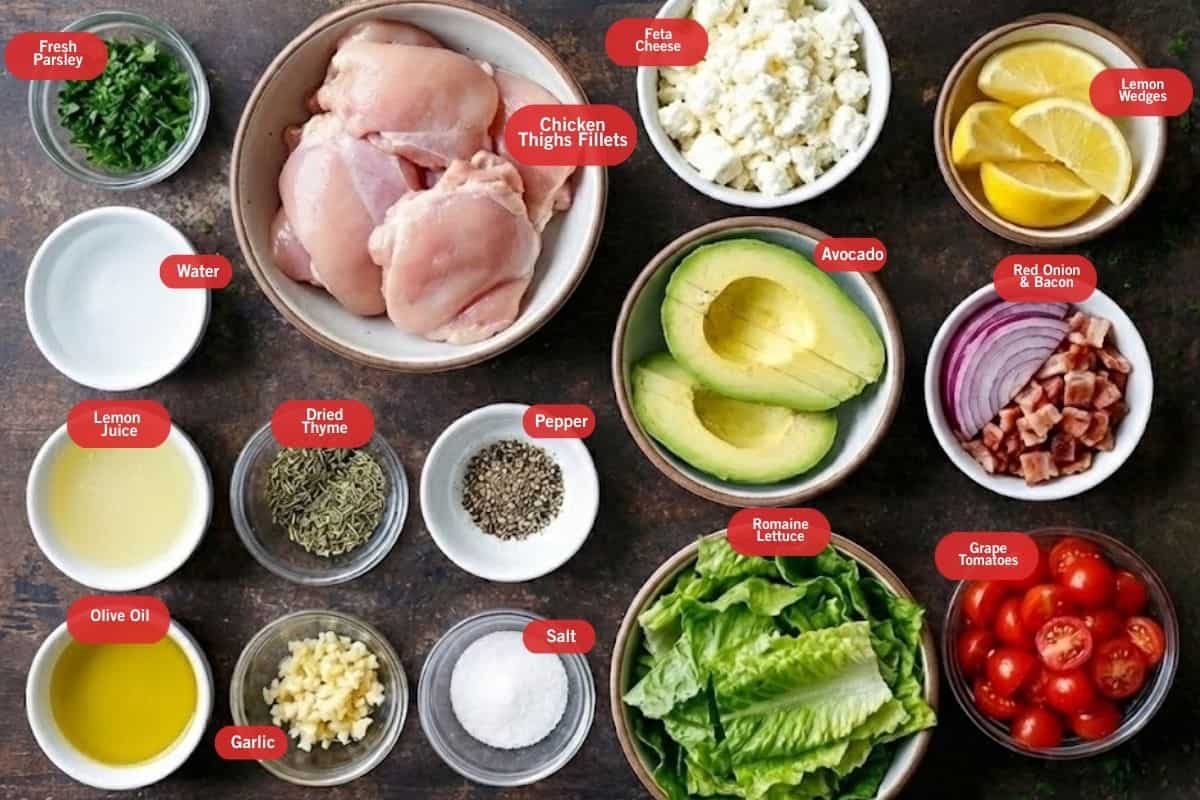 Flat lay photo of ingredient shot of fresh parsley, chicken thighs fillet, feta cheese, lemon wedges, red onion and bacon, grape tomatoes, romaine lettuce, salt, pepper, garlic, dried thyme, olive oil, lemon juice, water - 2
