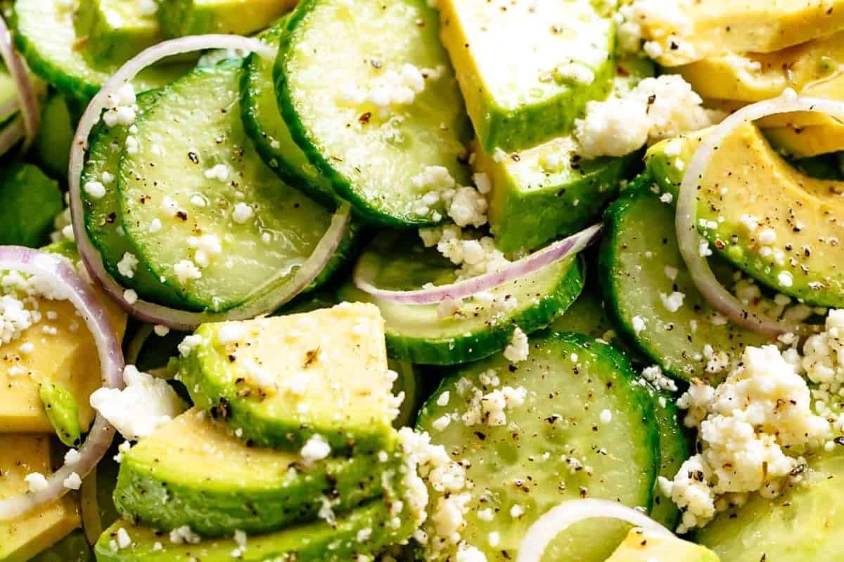 Add the cucumber slices, avocado, feta and onion slices into the dressing and toss well.  - 4
