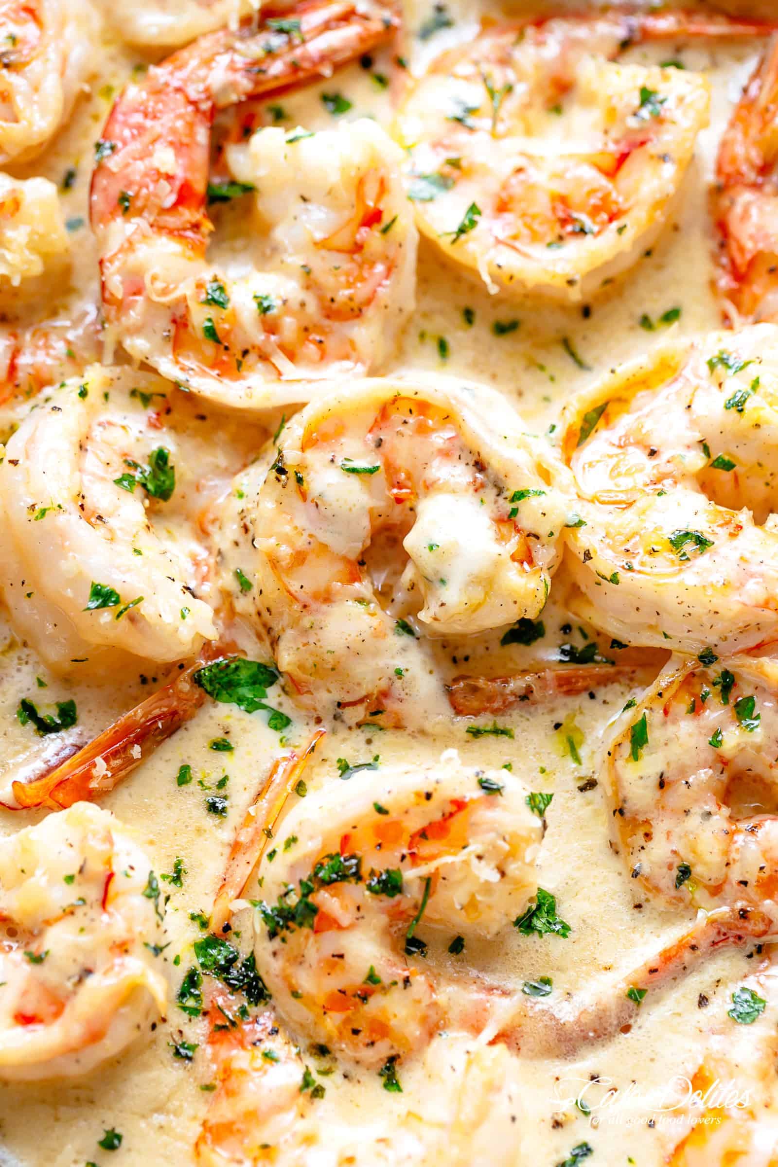 A close up image of Creamy Garlic Shrimp in a rustic and buttery cream sauce! | cafedelites.com