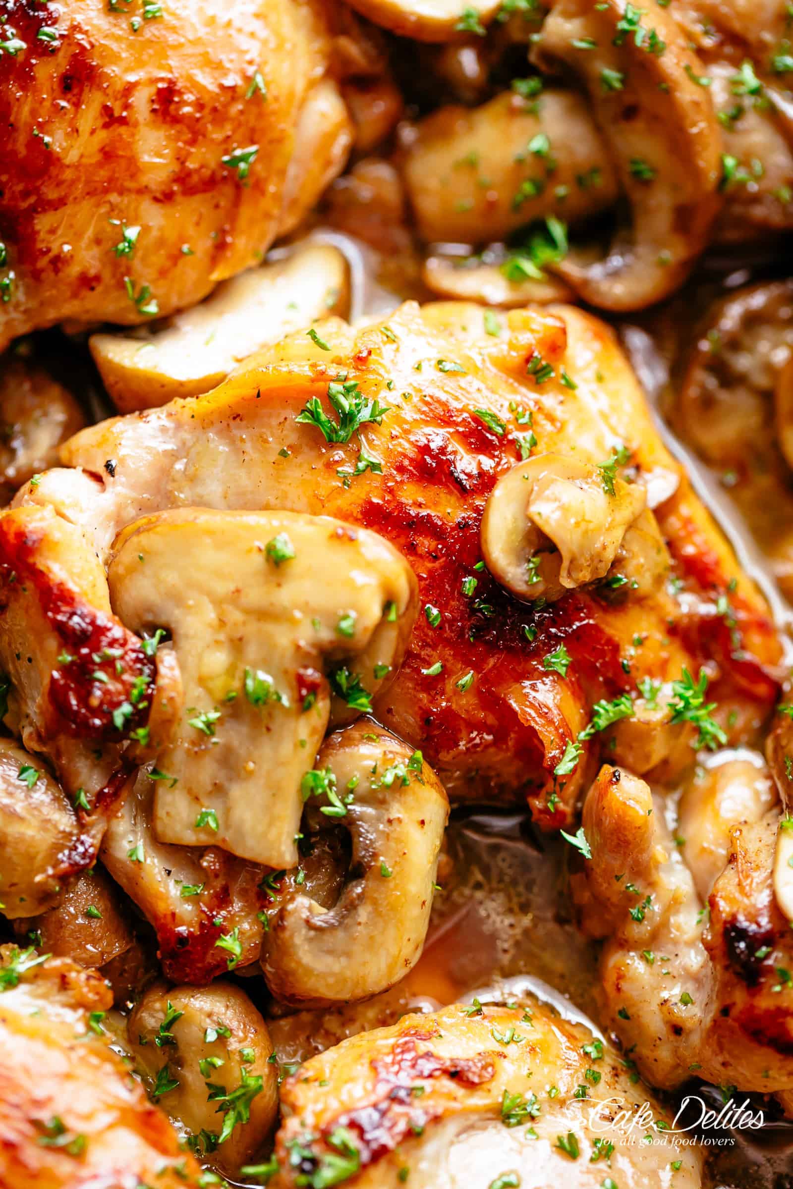 Golden seared Garlic Mushroom Chicken Thighs in a delicious, buttery sauce with a sprinkle of herbs | cafedelites.com