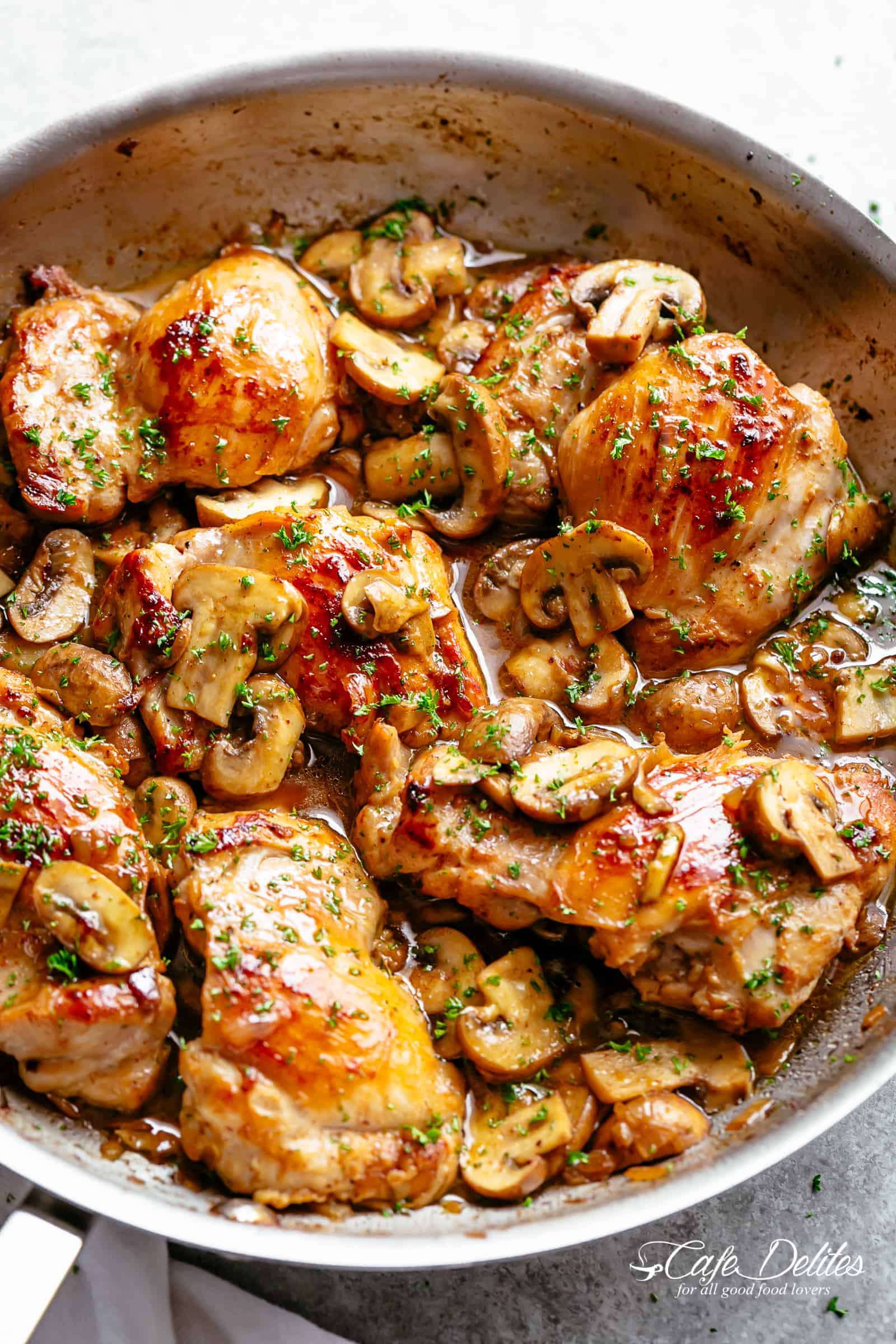 Golden seared chicken thighs in a delicious, buttery garlic mushroom sauce with a sprinkle of herbs is THE weeknight dinner everyone raves about! Serve over rice, pasta, mashed potatoes OR lower carb options like mashed cauliflower or zucchini noodles! | cafedelites.com