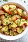 Garlicky Herb Red Potato Salad is ridiculously easy to make and packed with flavour! Slathered in the best and most delicious herb dressing with olive oil, a slight tang of vinegar, a kick of garlic and the most incredible flavours of fresh herbs, this Potato Salad Recipe will be a hit on your dinner table! | cafedelites.com