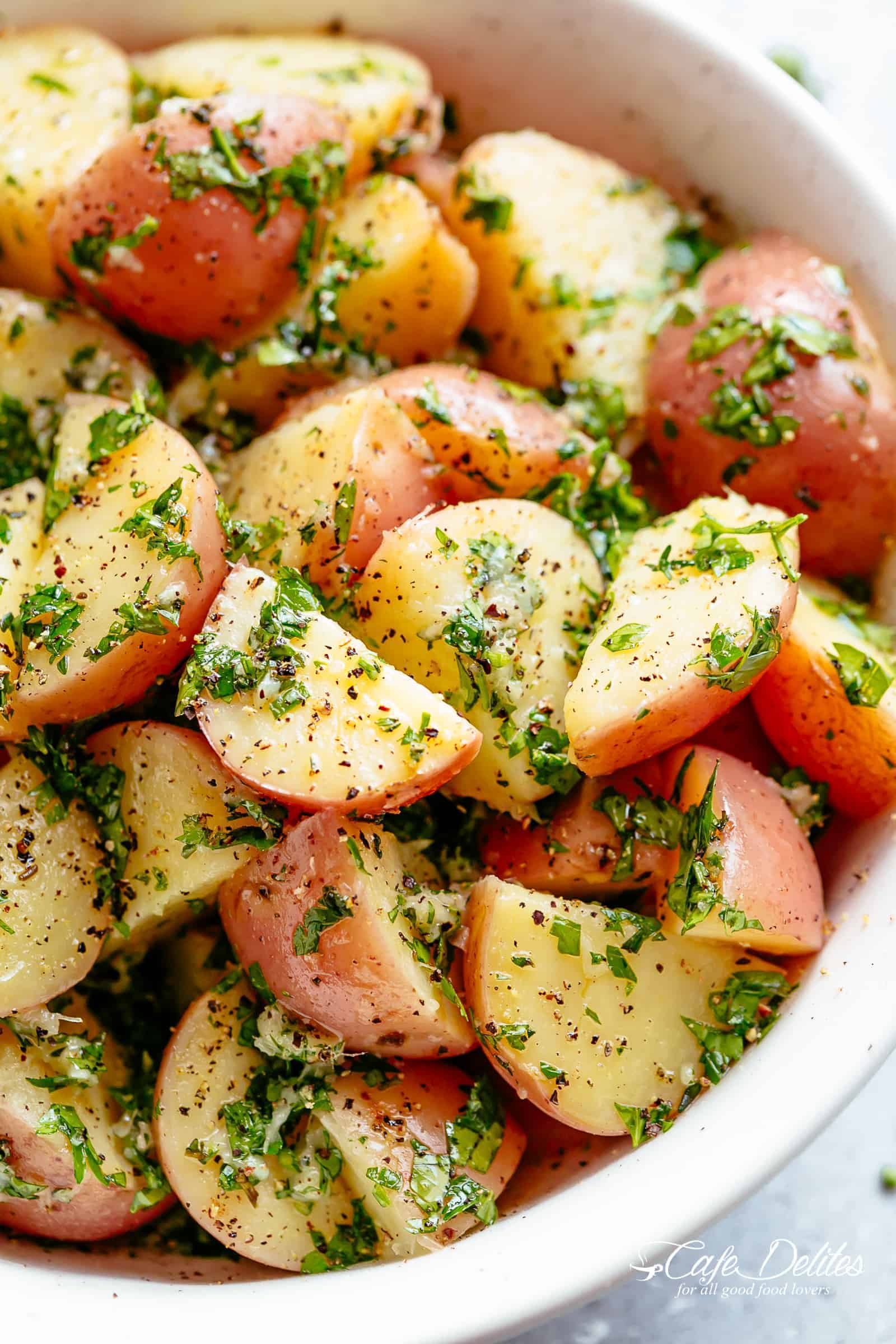 Garlicky Herb Red Potato Salad is ridiculously easy to make and packed with flavour! Slathered in the best and most delicious herb dressing with olive oil, a slight tang of vinegar, a kick of garlic and the most incredible flavours of fresh herbs, this Potato Salad Recipe will be a hit on your dinner table! | cafedelites.com