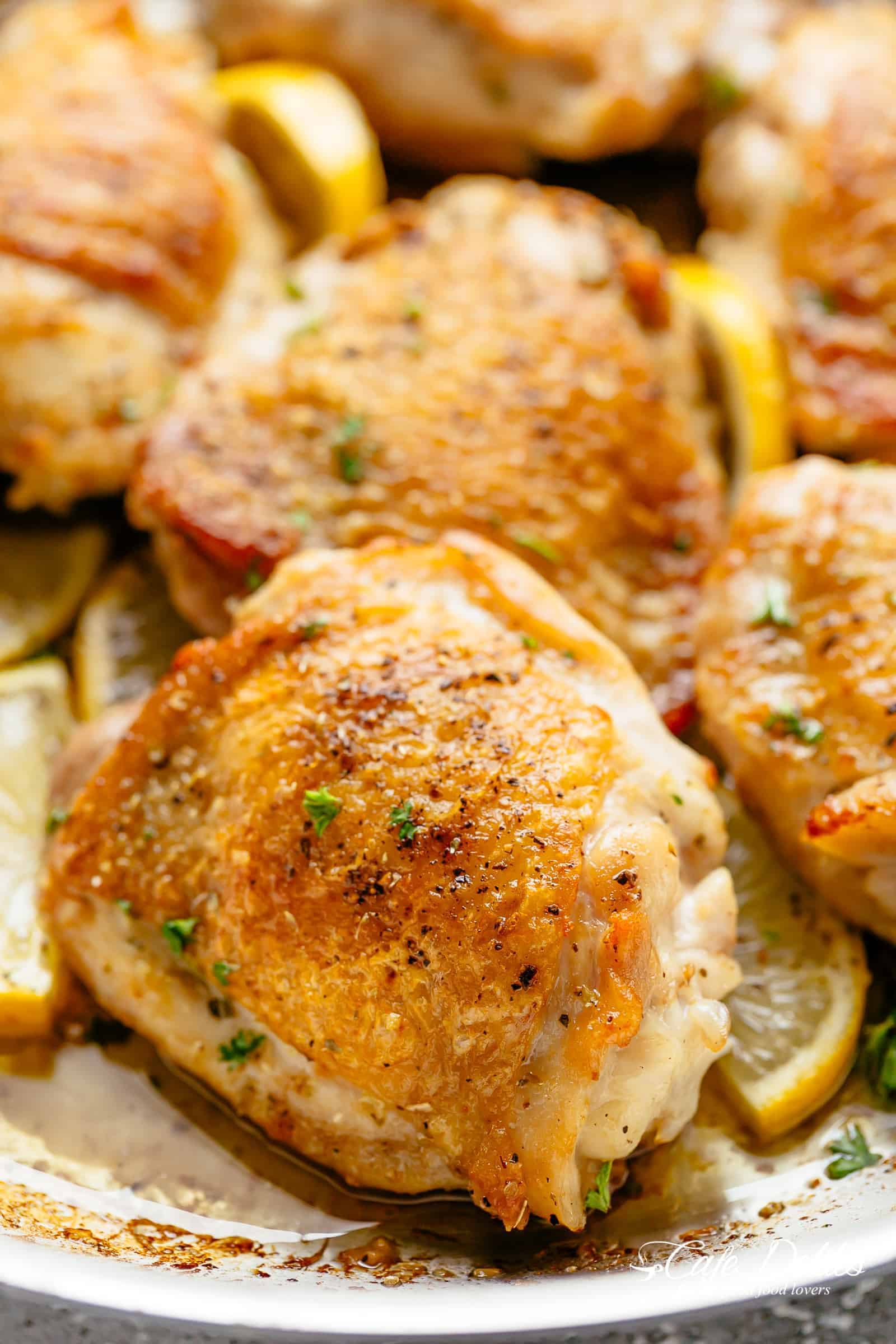 Roast Lemon Chicken thighs with crispy skin pan, seared then oven baked for tender and juicy chicken full of flavour! Your new favourite chicken recipe is here! With a kick of garlic and a touch of herbs, simple to make with minimal ingredients and maximum flavour! | cafedelites.com