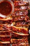 Oven Barbecue Ribs slathered in the most delicious sticky barbecue sauce with a kick of garlic and optional heat! Juicy melt-in-your-mouth oven baked Barbecue Pork Ribs are fall-off-the-bone delicious! Double up on incredible flavour with an easy to make dry rub first, then coat them in a seasoned barbecue sauce mixture so addictive you won't stop at one! Finger licking good ribs right here! | cafedelites.com