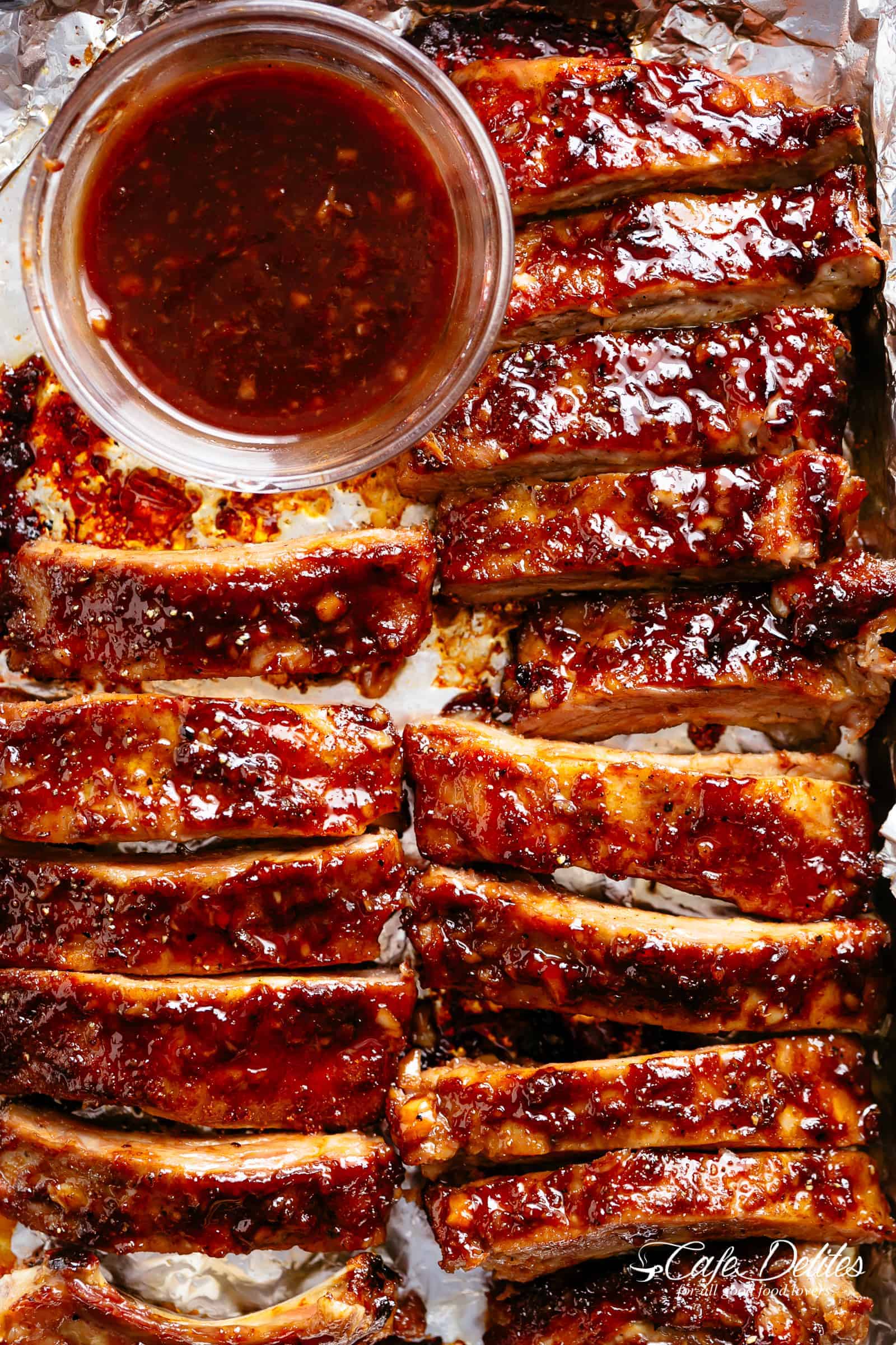 Image of barbecue ribs just removed from the oven, covered in BBQ sauce marinade.