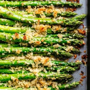 Garlic Butter Asparagus with Crispy Parmesan lying on a tray