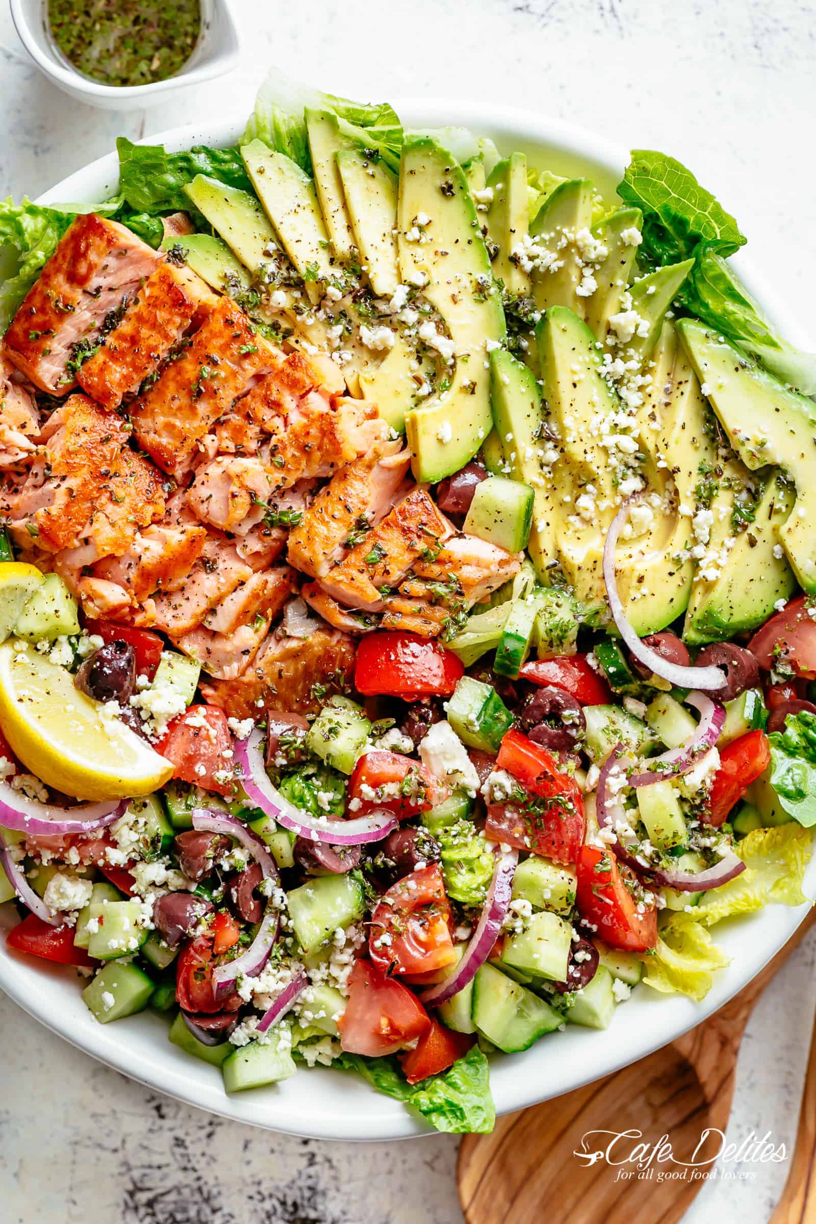 Avocado Salmon Salad with an incredible lemon herb Mediterranean dressing! Loaded with cucumber, olives, tomatoes and feta cheese! | cafedelites.com