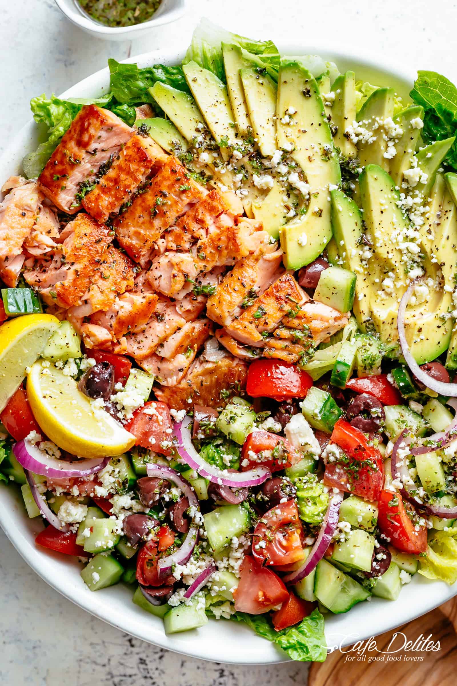 Avocado Salmon Salad with an incredible lemon herb Mediterranean dressing! Loaded with cucumber, olives, tomatoes and feta cheese! | cafedelites.com