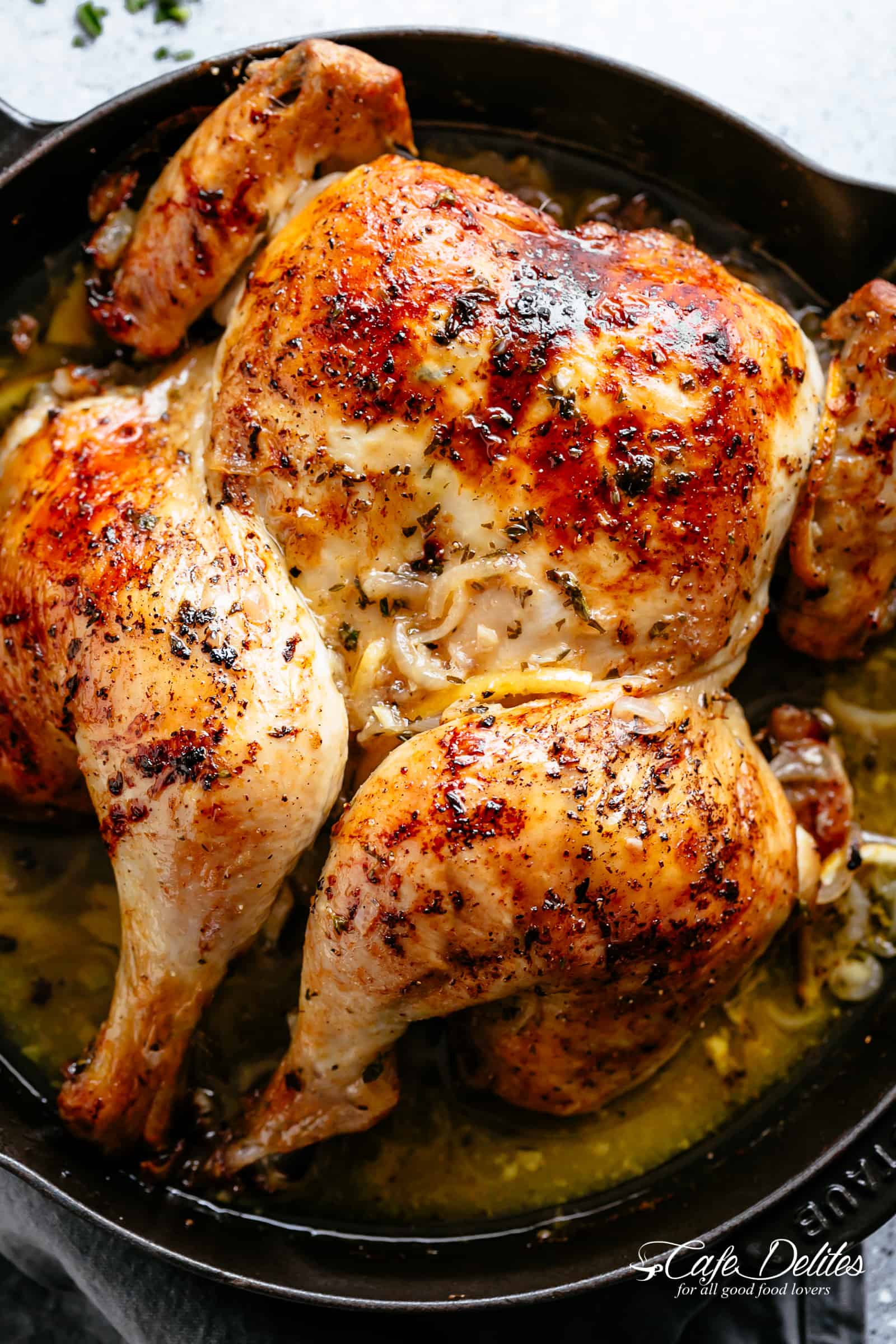 Tender and juicy Lemon Garlic Roast Chicken with crispy, rich and flavourful skin, so much flavour and easy to find ingredients! Garlic, onions, lemons, olive oil, fresh herbs and a splash of white wine (optional) make this one amazing roast chicken recipe! You'll be so surprised at how moist the meat is! | cafedelites.com