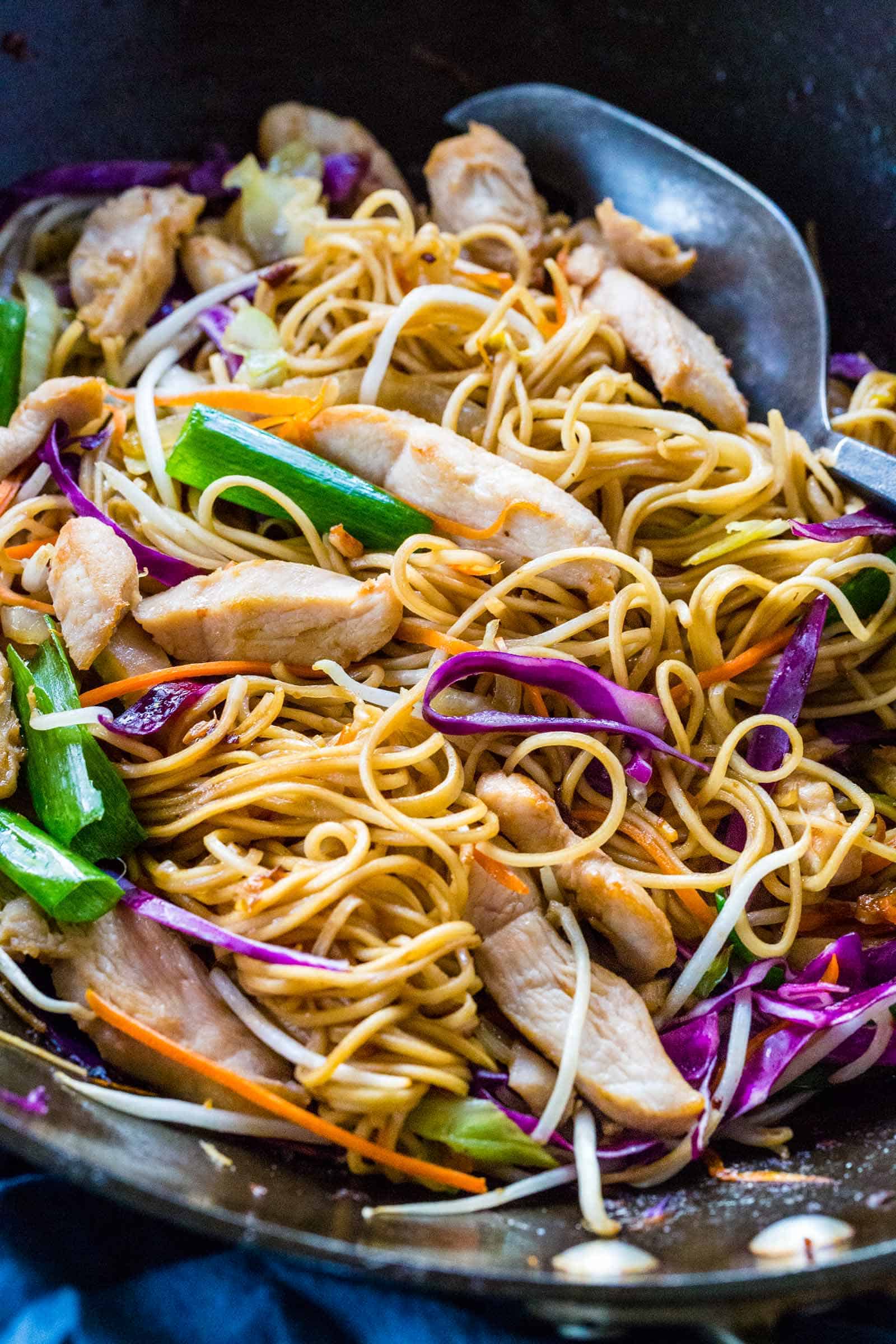 Wok spatula mixing chicken chow mein