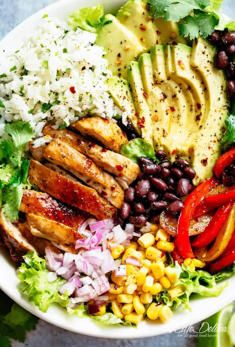 Fajita Chicken Burrito Bowl is packed with juicy golden chicken, cilantro lime rice, avocado and a delicious dressing! Perfect for meal prep! | cafedelites.com