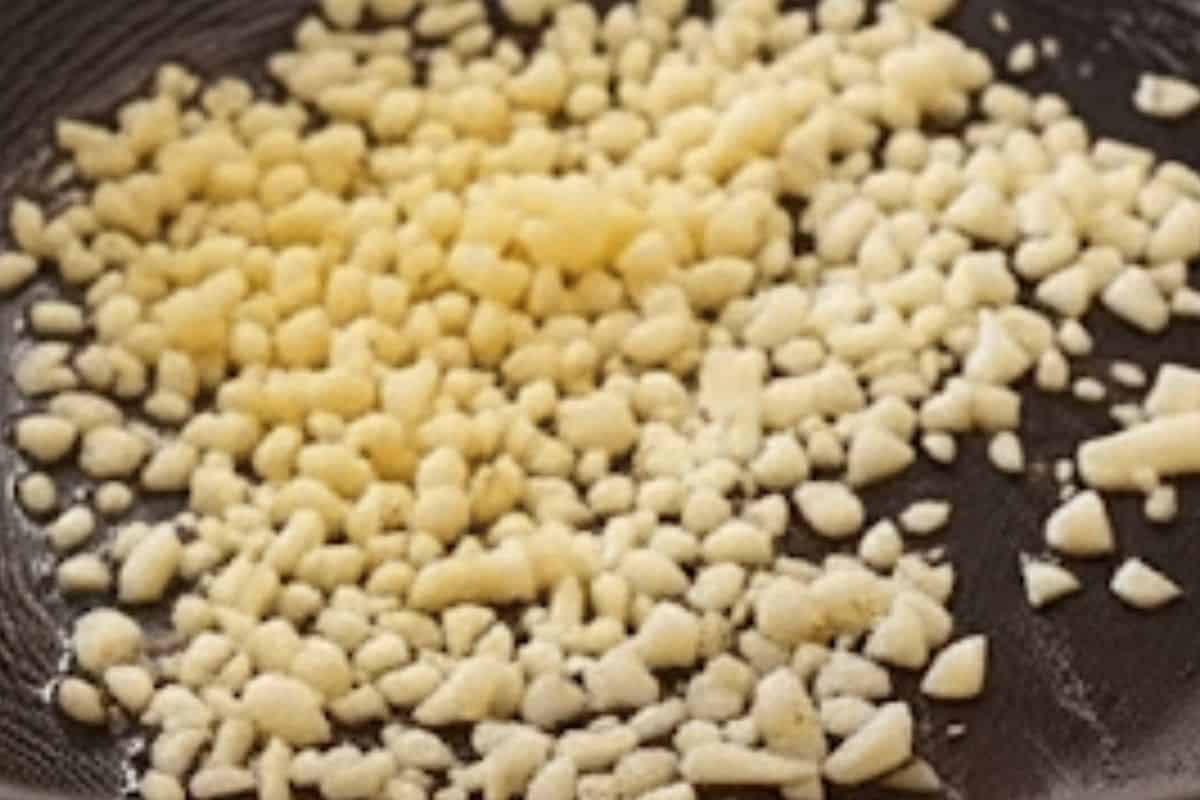 Add garlic and ginger into the wok and cook until fragrant. 