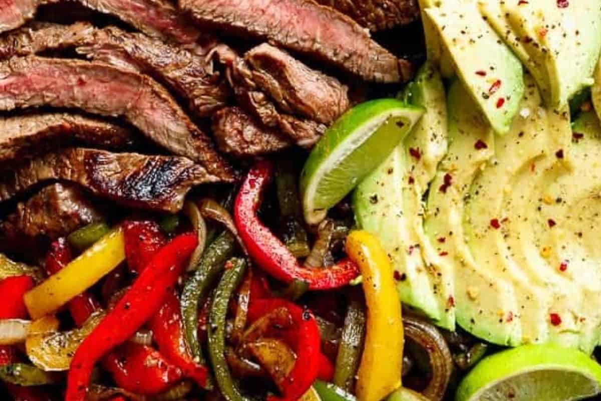 Slice the steak thinly against the grain. Fill warm tortillas with steak, vegetables, avocado, cilantro, and sour cream, then drizzle with the remaining marinade.