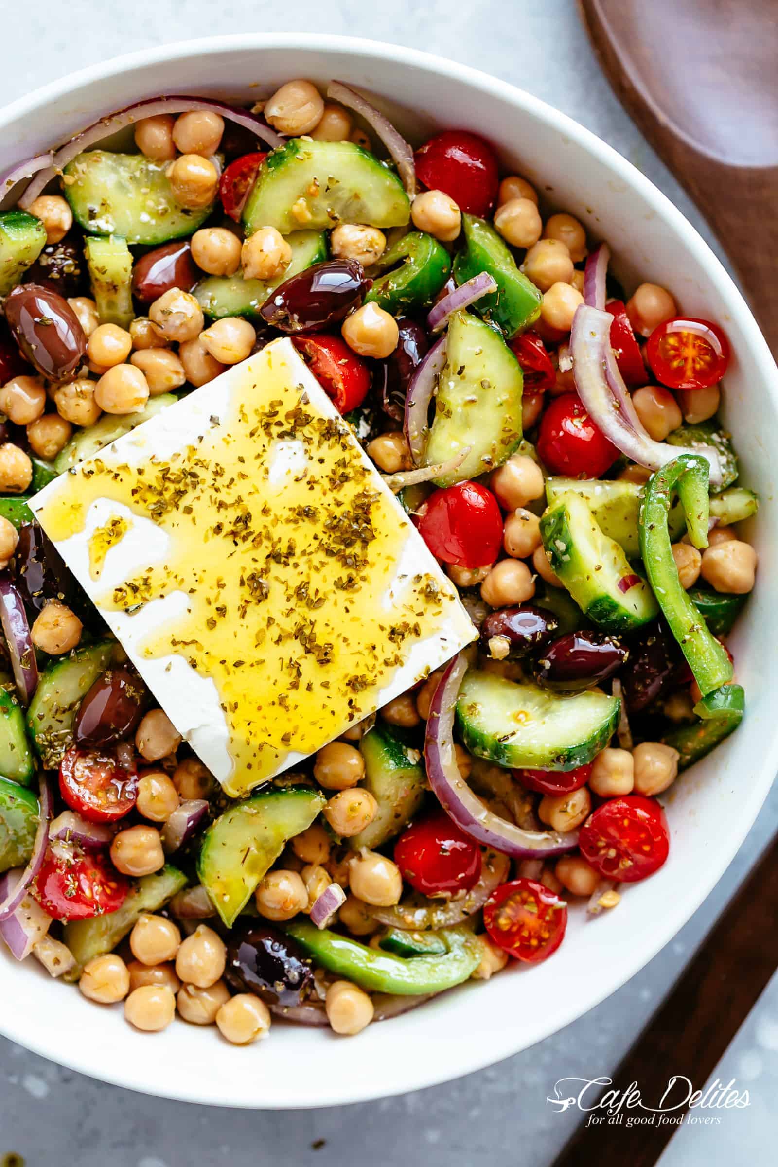 Greek Chickpea Salad with an authentic greek salad dressing is a favourite salad to serve as a main OR as a side! Healthy and filling! | cafedelites.com