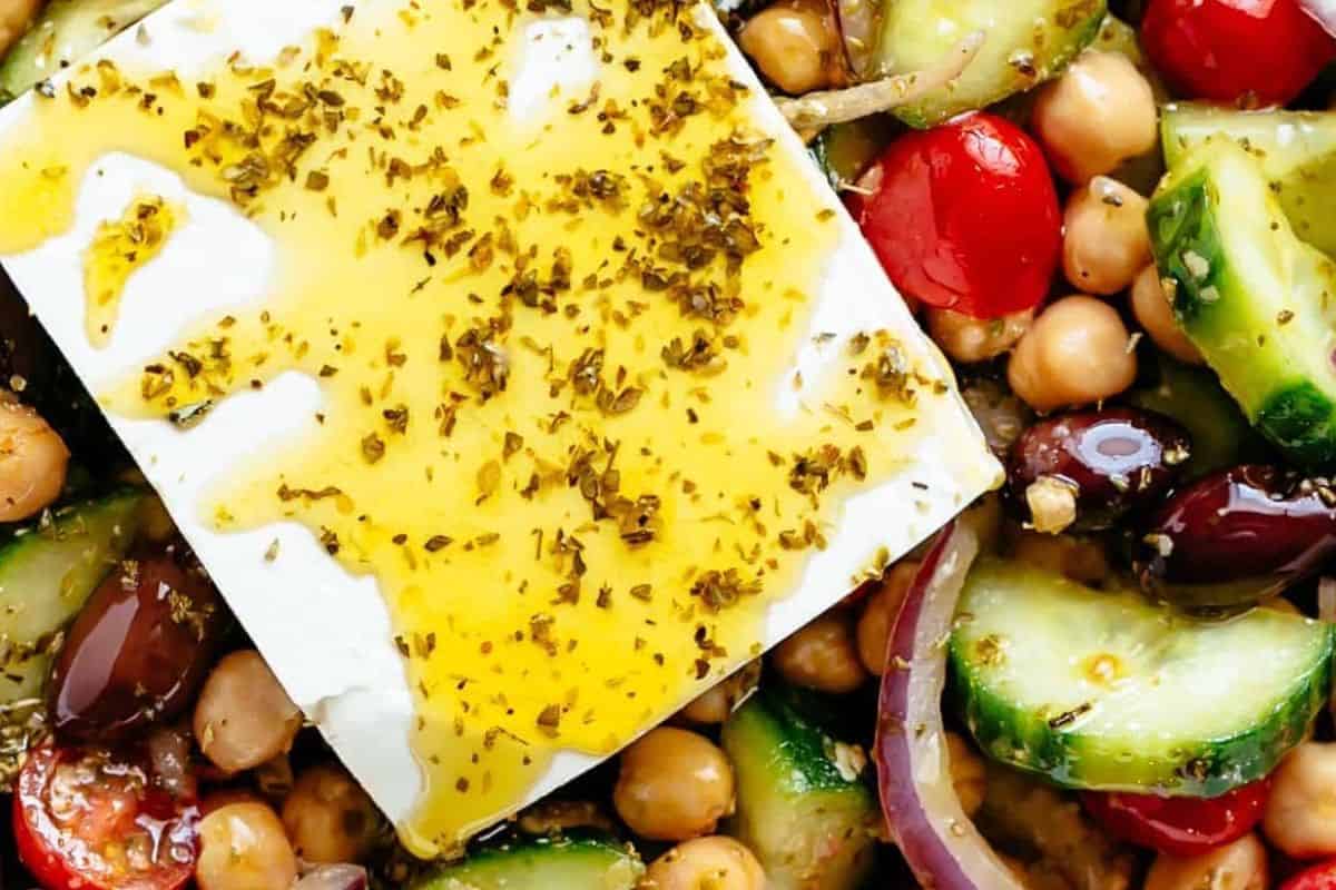Place a block of feta on top of the salad and drizzle with the remaining dressing.