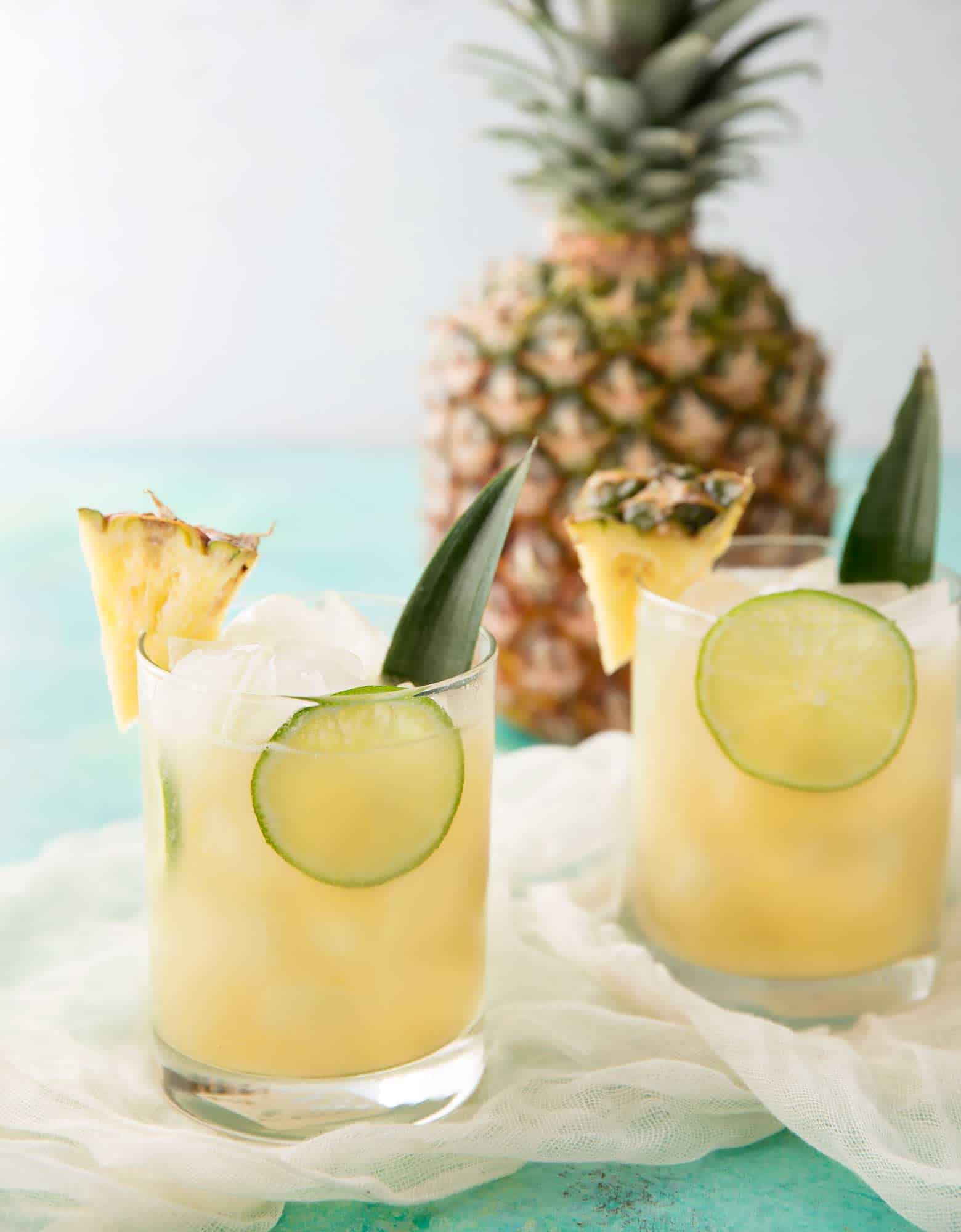 One sip of this tropical Pineapple Rum Punch and you'll be beachside in your mind! A refreshing cocktail to enjoy in your own home! | cafedelites.com