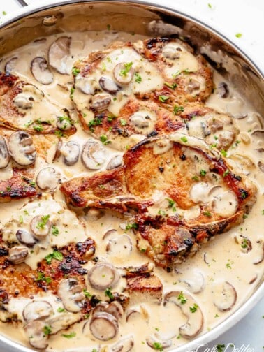 Seared Pork Chops with a creamy garlic mushroom sauce in a pan