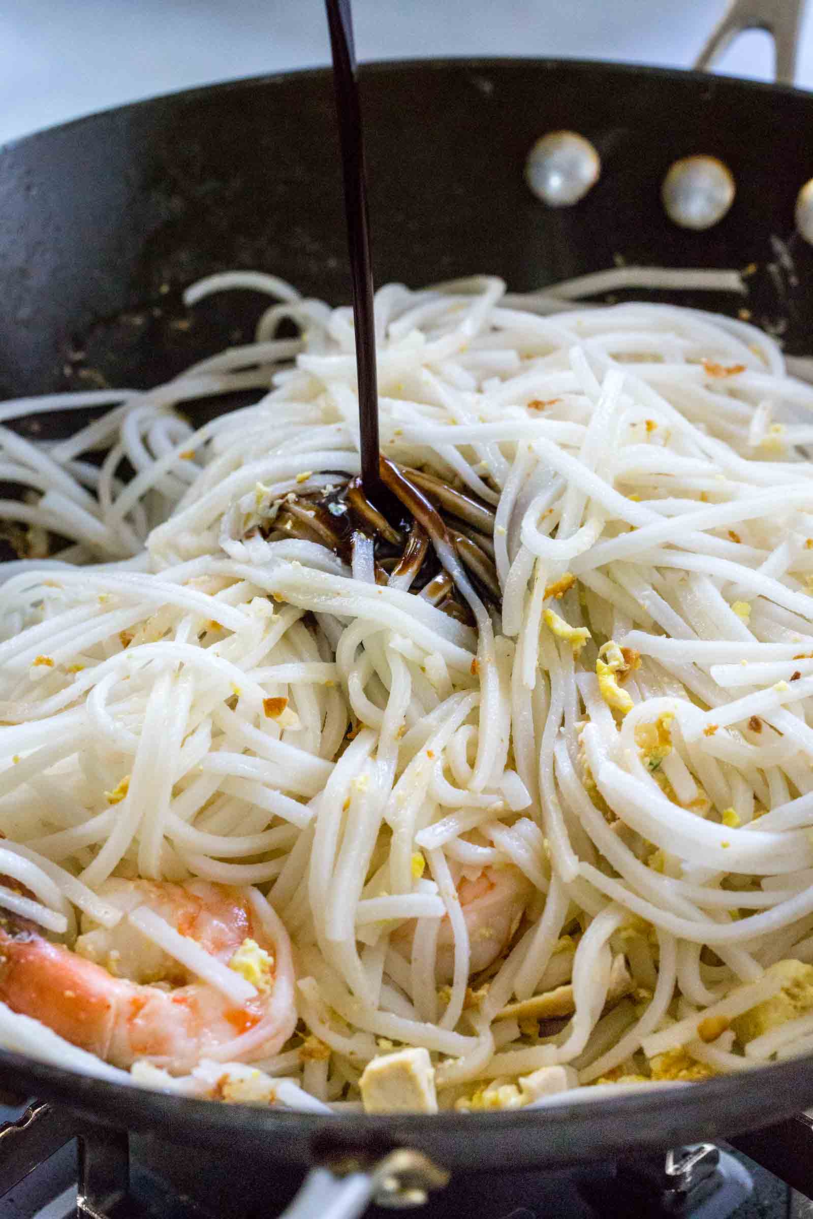 Pad thai sauce poured over noodles