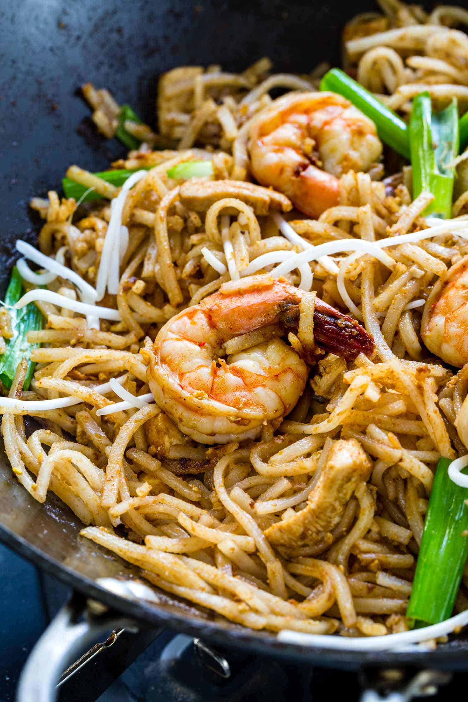 shrimp and chicken pad thai in a wok