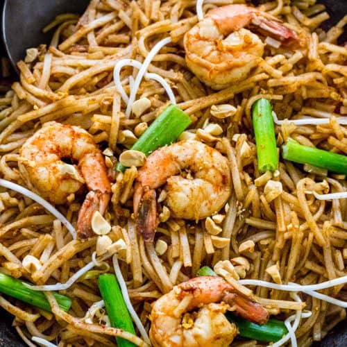 pad thai cooking in a wok in a pan