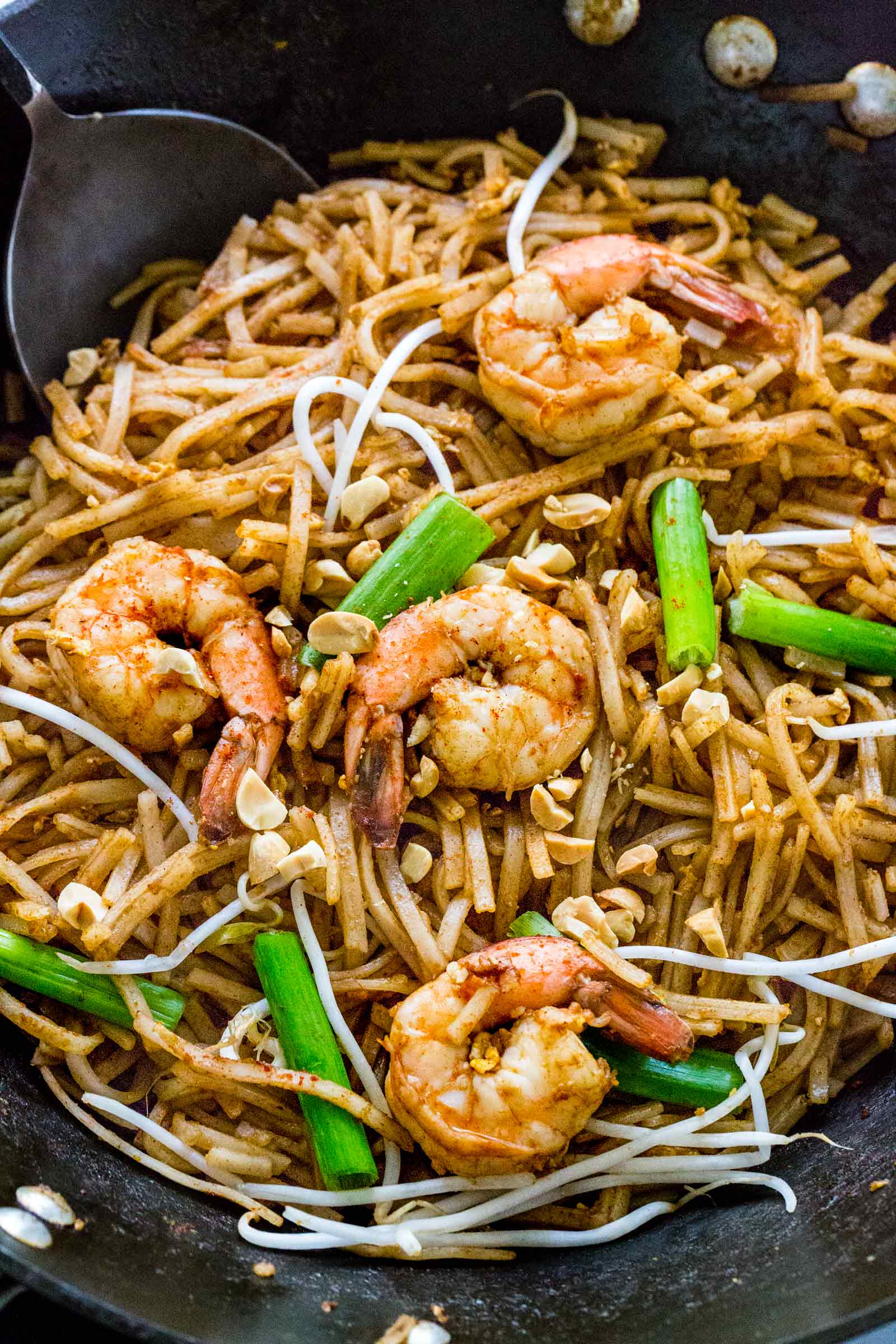 pad thai cooking in a wok