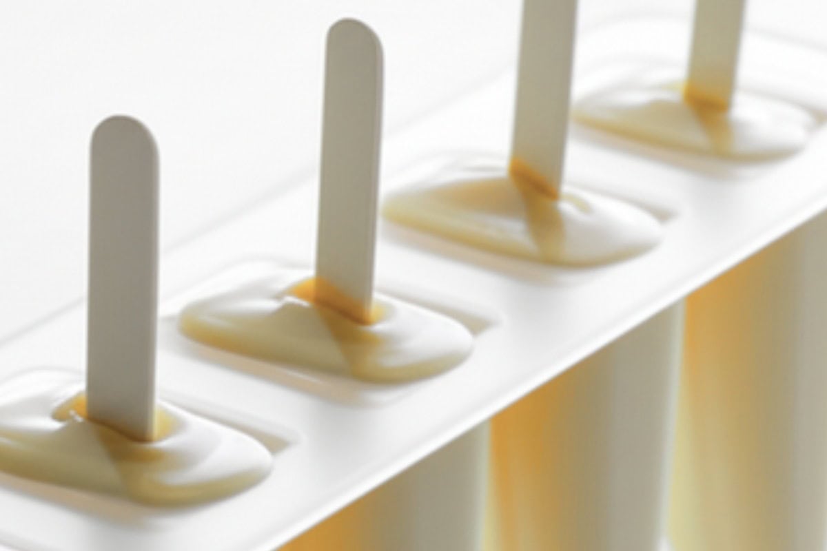 Pour the mixture into the popsicle molds and insert a stick.