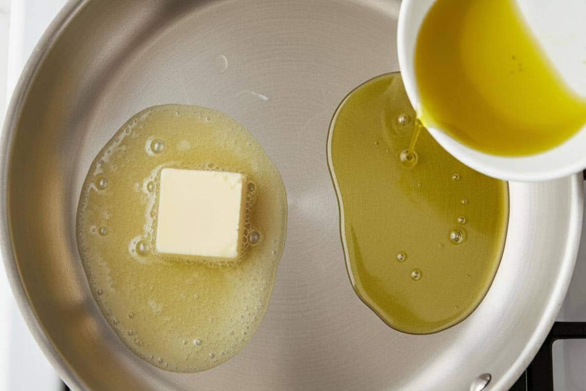 Heating butter and olive oil in a large skillet.