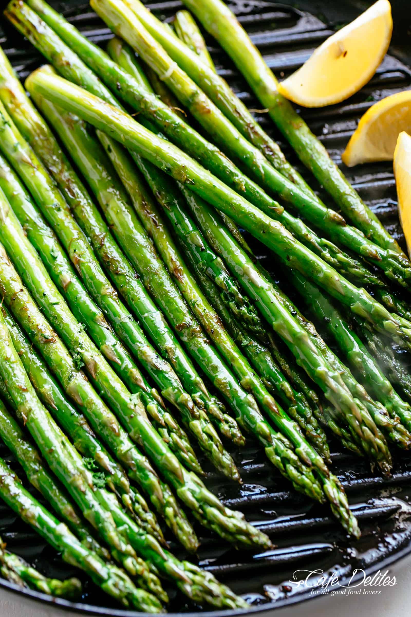 Grilled Asparagus takes minutes! Simply toss in olive oil and garlic, season with salt and pepper and throw them directly on the grill! | cafedelites.com