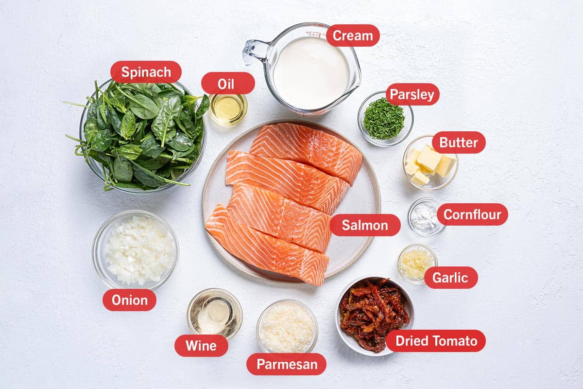 Image of the ingredients needed for this recipe, specifically: salmon, oil, cream, parsley, butter, cornflour, garlic, dried tomato, parmesan, wine, onion, spinach.