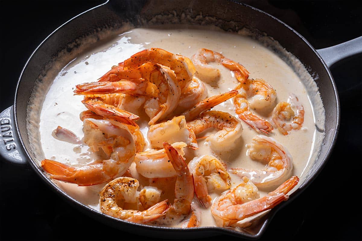 Shrimp are being added to the cream.