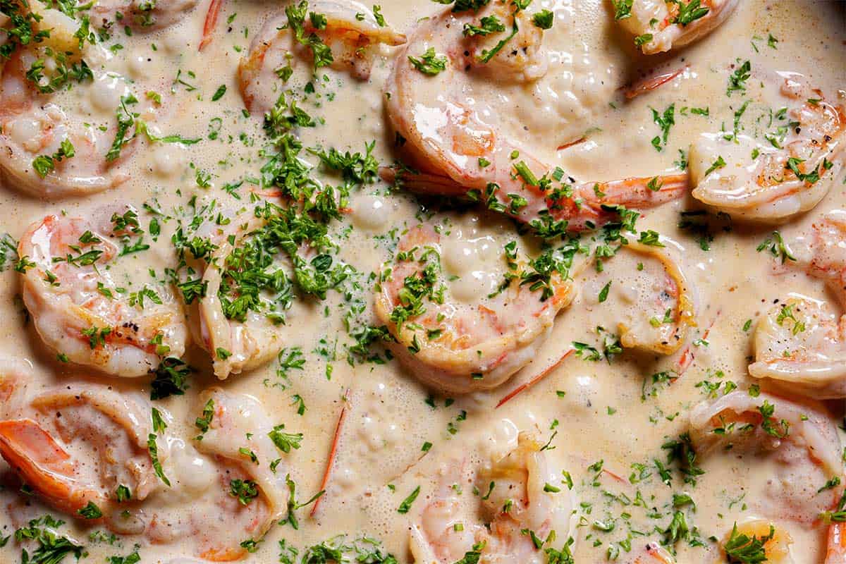 Close-up image of the shrimp in sauce, sprinkled with parsley.