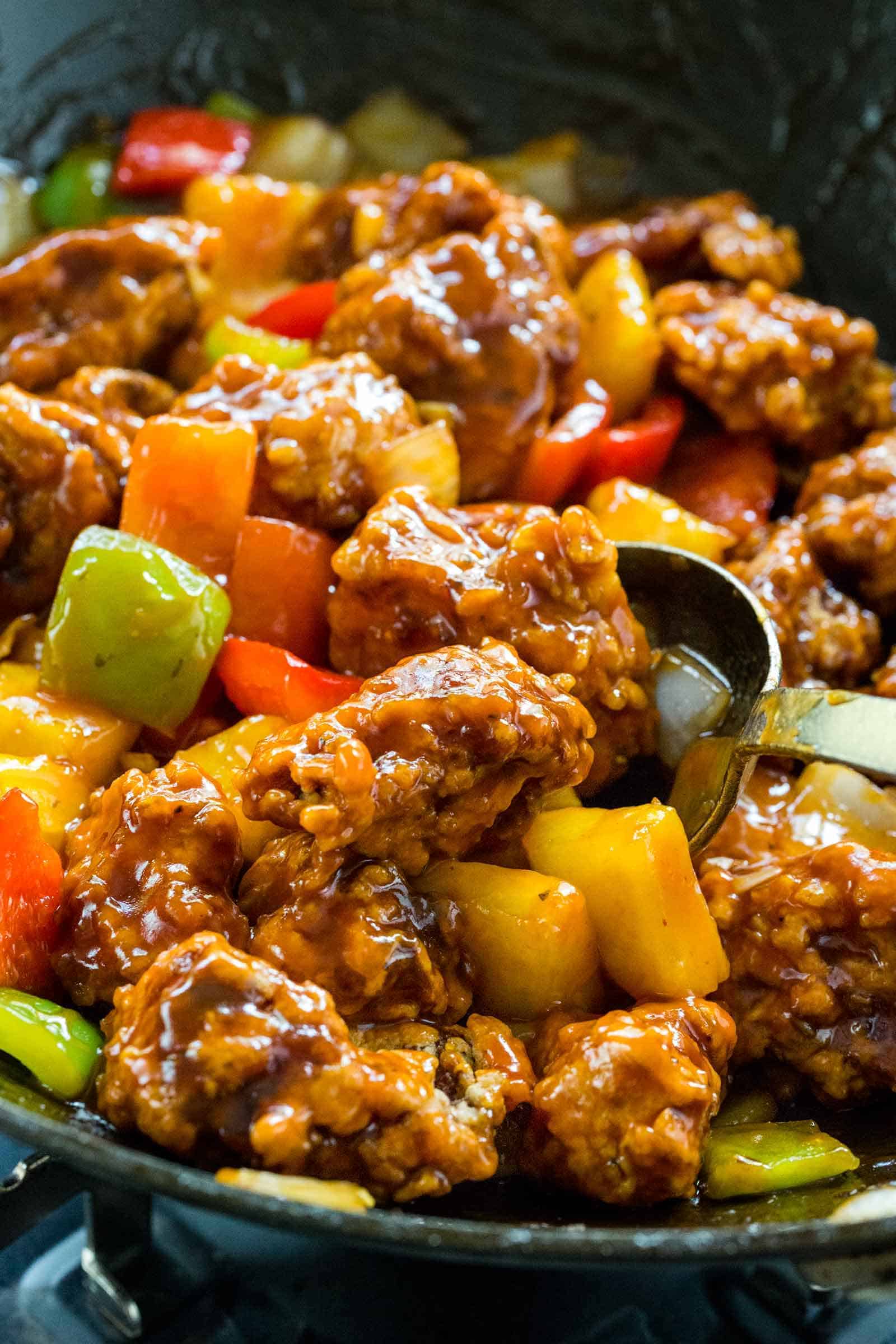 homemade sweet and sour pork cooking in a wok