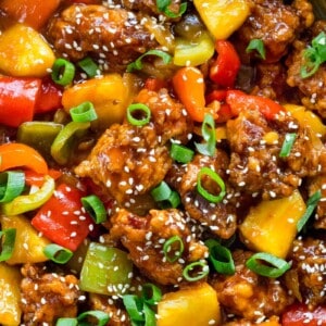 Top view of sweet and sour pork with vegetables in a wok