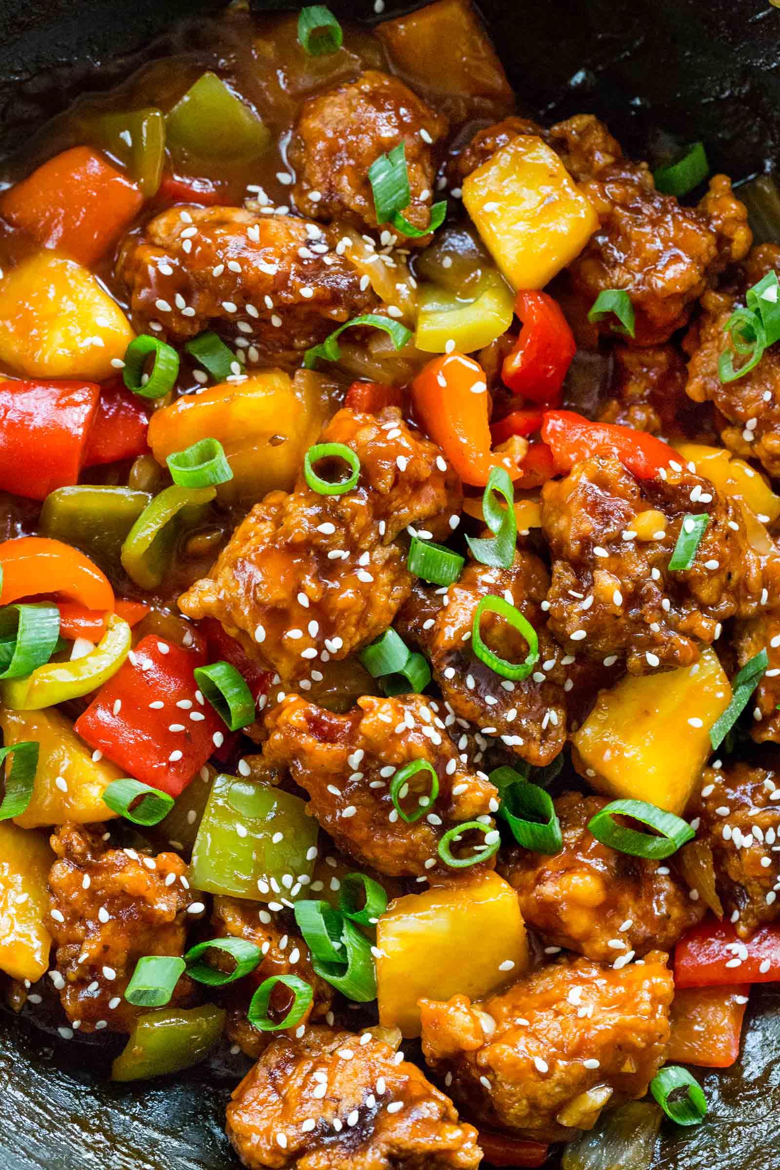 sweet and sour pork with vegetables in a wok