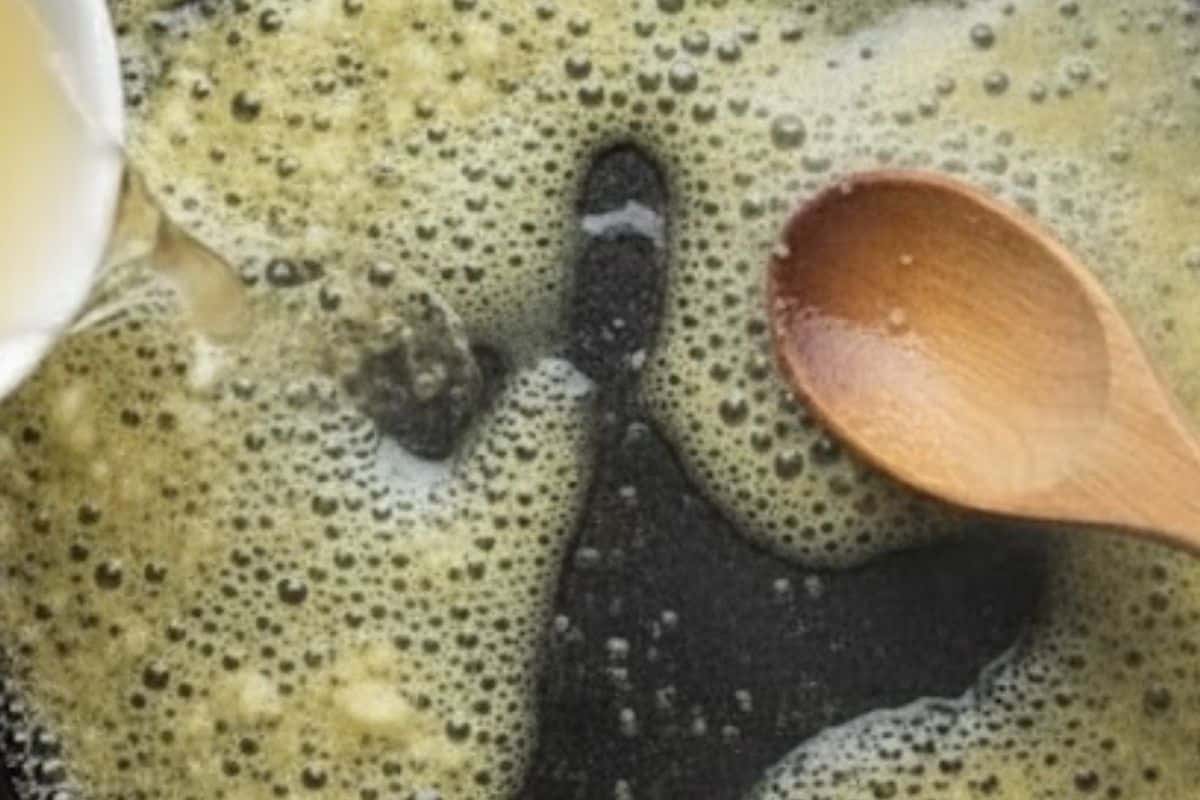 Pour in the white wine and scrape up any browned bits from the bottom. Let it simmer until reduced.