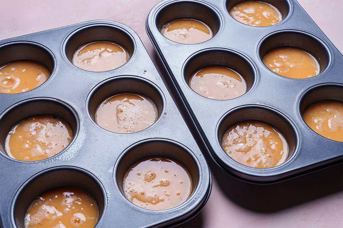 An image of muffin tins filled halfway with egg mixture.