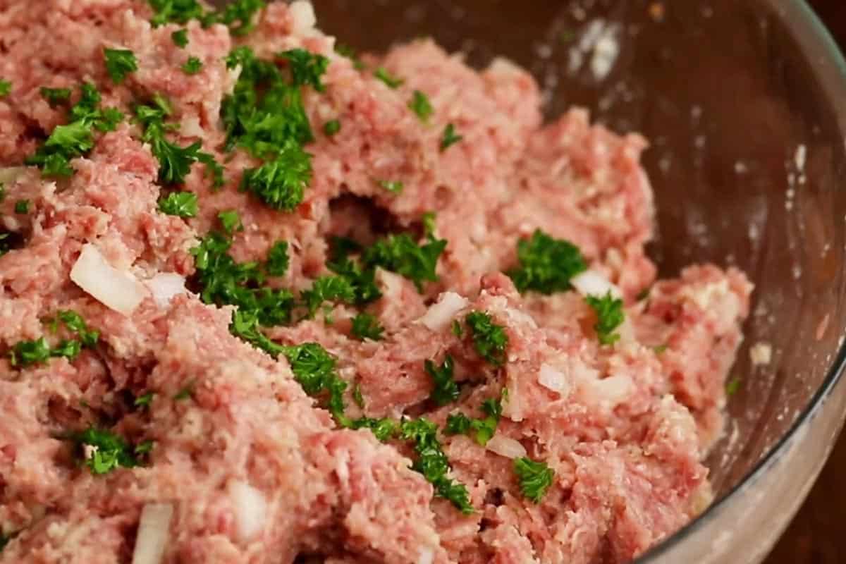 Combined milk, cream, egg and garlic with the breadcrumbs and seasonings. Then added the onion, meat and parsley in a mixing bowl.