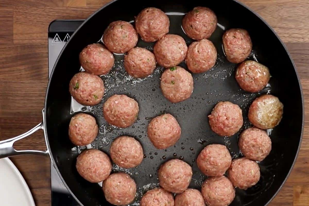 Frying the meatballs in a pan.
