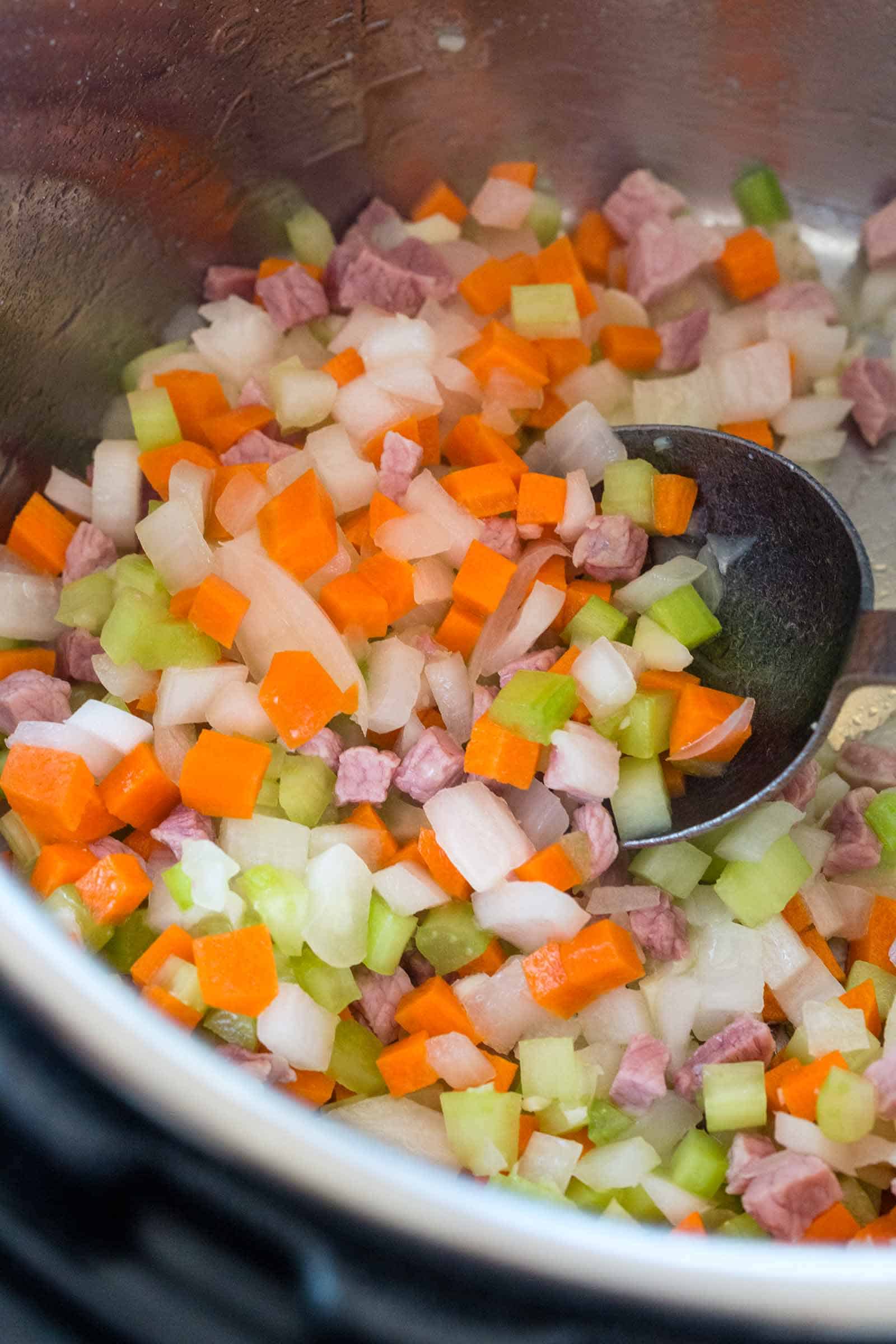 pancetta, garlic, onions, and carrots cooking in the Instant Pot