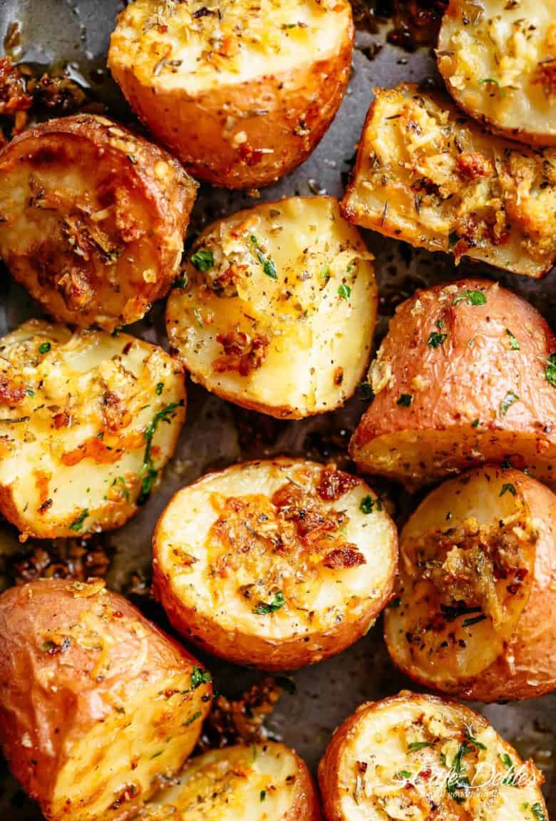 Herbs, garlic, and parmesan cheese are roasted together to make the best Crispy Browned Butter Parmesan Roasted Potatoes! A delicious side dish with so much flavour, these potatoes go with ANYTHING! | cafedelites.com