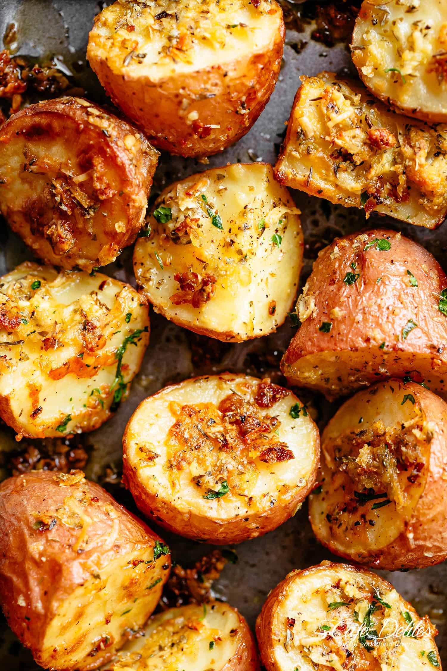 Herbs, garlic, and parmesan cheese are roasted together to make the best Crispy Browned Butter Parmesan Roasted Potatoes! A delicious side dish with so much flavour, these potatoes go with ANYTHING! | cafedelites.com